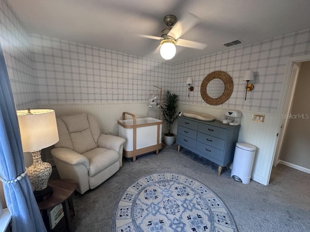 sitting room featuring carpet and ceiling fan