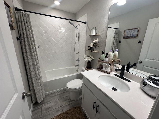 full bathroom featuring shower / tub combo with curtain, vanity, and toilet