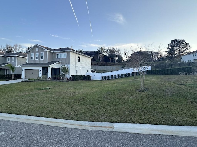 exterior space with a garage and a lawn