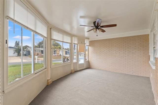 unfurnished sunroom with ceiling fan