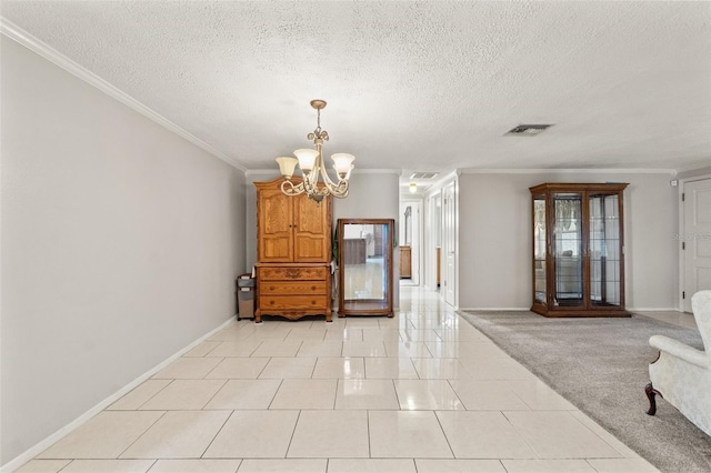 interior space featuring ornamental molding, a chandelier, and a textured ceiling