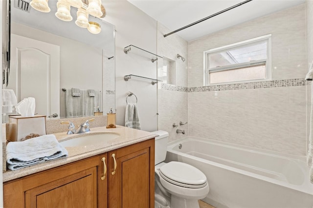 full bathroom with vanity, tiled shower / bath combo, and toilet