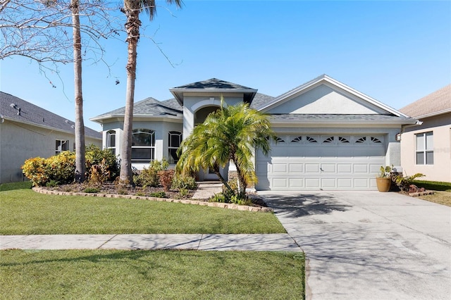 ranch-style home featuring a garage and a front lawn