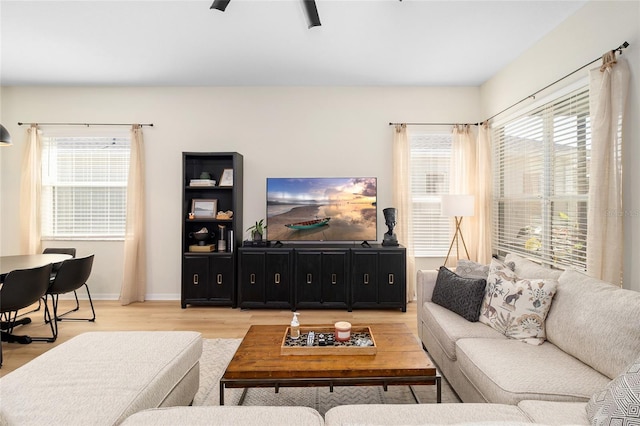 living room featuring hardwood / wood-style floors and ceiling fan