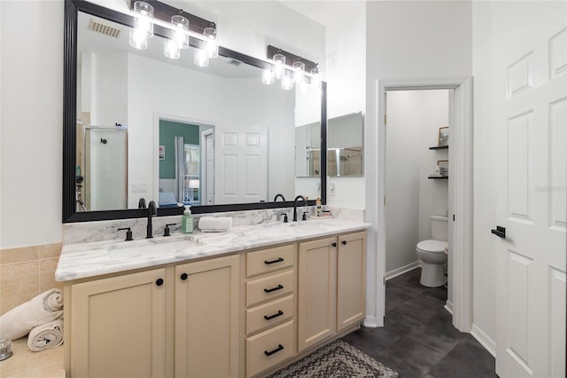 bathroom with vanity, toilet, and a shower with door