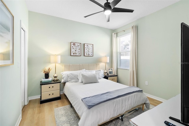 bedroom featuring light hardwood / wood-style floors and ceiling fan