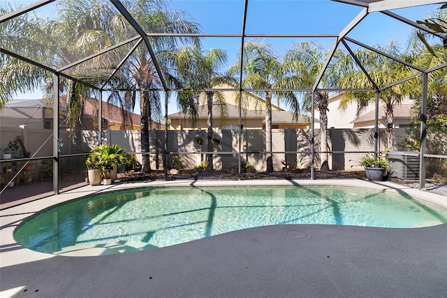 view of swimming pool with glass enclosure