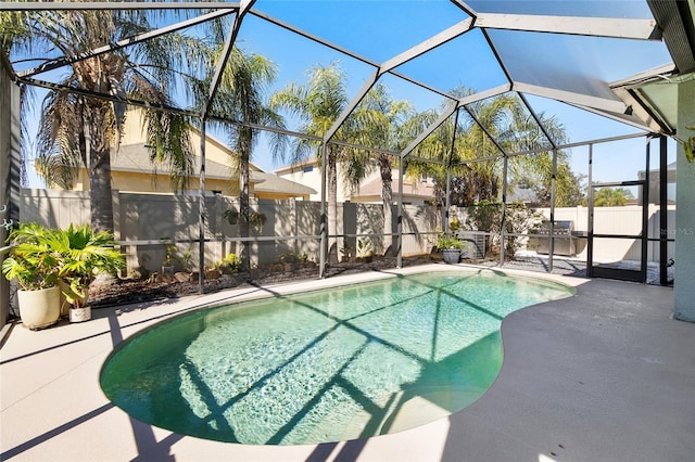 view of swimming pool featuring a lanai and a patio