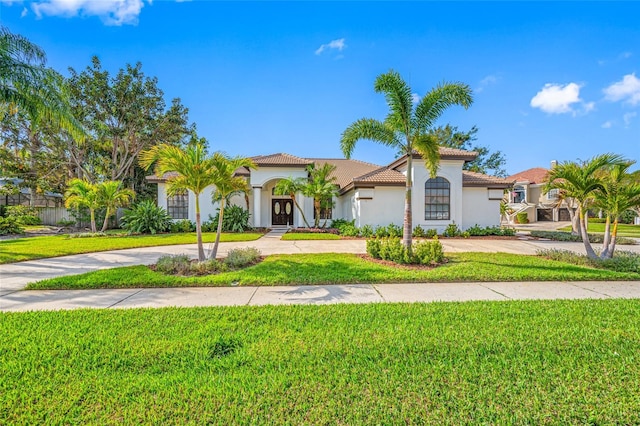 mediterranean / spanish-style home with a front lawn