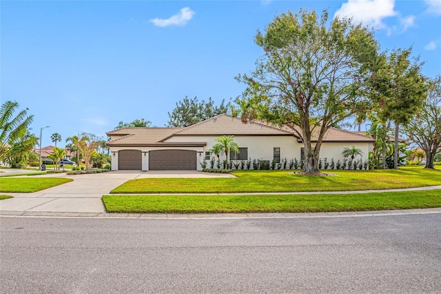 view of front of house featuring a garage and a front lawn