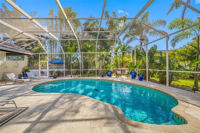 view of swimming pool featuring a patio area and glass enclosure