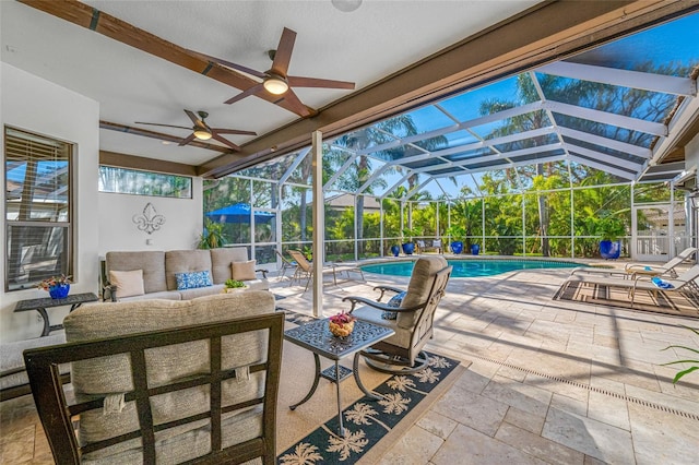 view of patio / terrace with glass enclosure, an outdoor hangout area, and ceiling fan