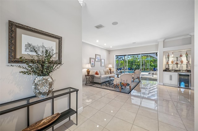 tiled living room with wine cooler, bar, and crown molding