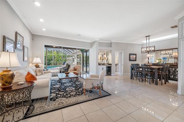 living room featuring wine cooler, light tile patterned floors, and crown molding