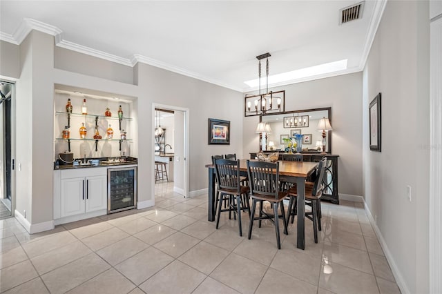 tiled dining area featuring ornamental molding, beverage cooler, and indoor wet bar