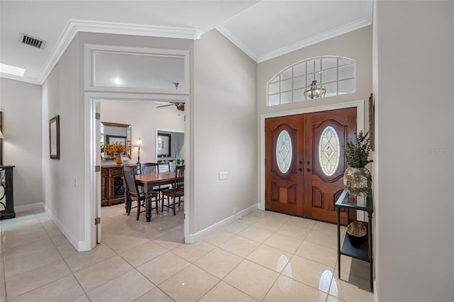 entryway featuring crown molding and light tile patterned floors