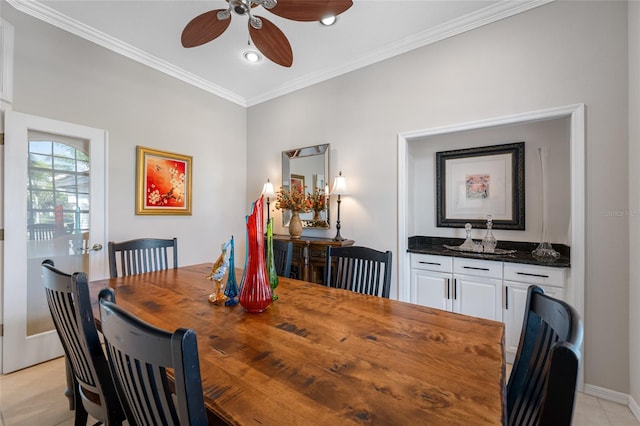 dining space featuring ceiling fan and ornamental molding