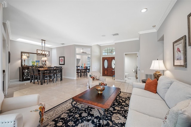 tiled living room with ornamental molding and a notable chandelier