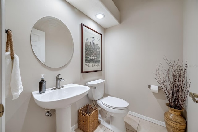 bathroom with toilet and tile patterned flooring