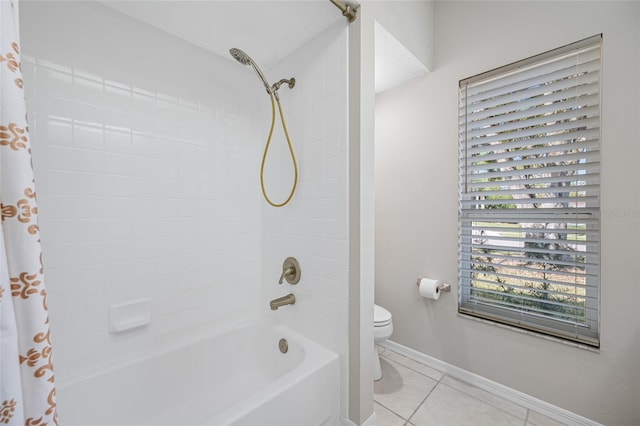 bathroom featuring tile patterned floors, toilet, and shower / tub combo with curtain