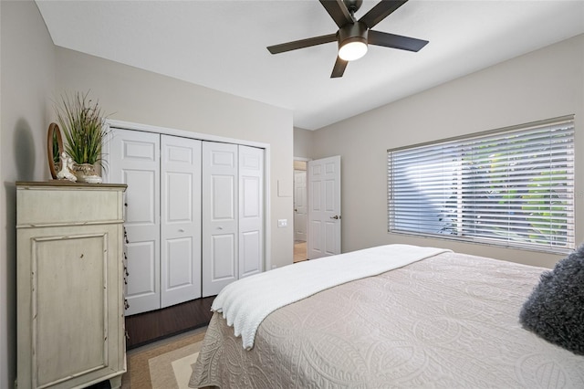 bedroom with ceiling fan, light wood-type flooring, and a closet