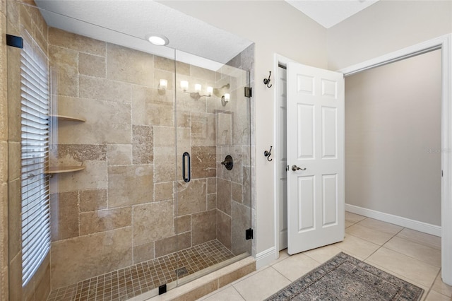 bathroom featuring a shower with door and tile patterned flooring