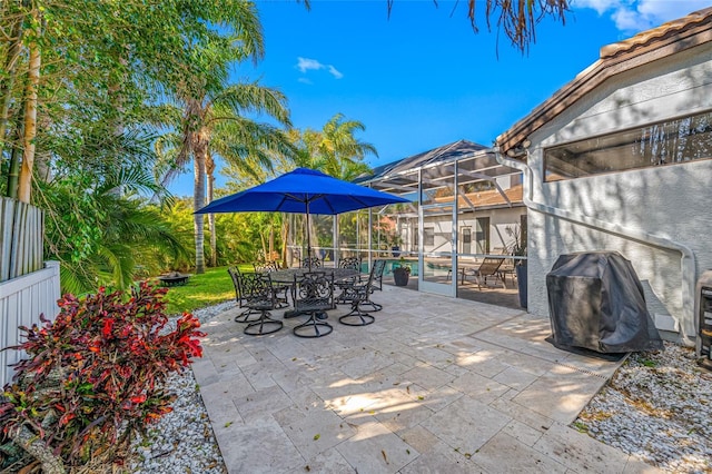 view of patio featuring glass enclosure