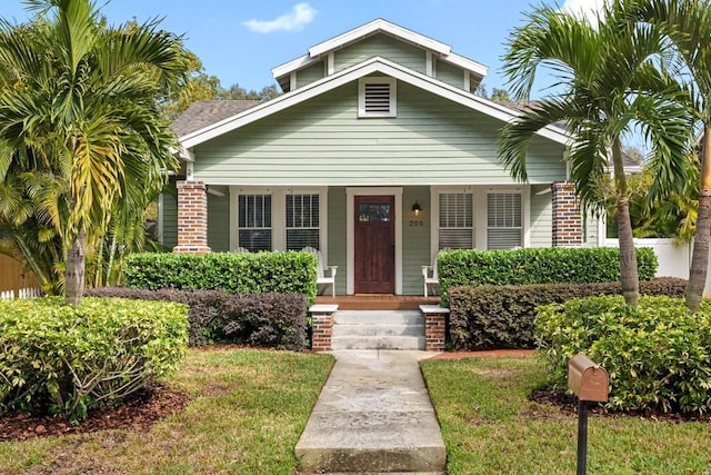 bungalow-style home with a front yard