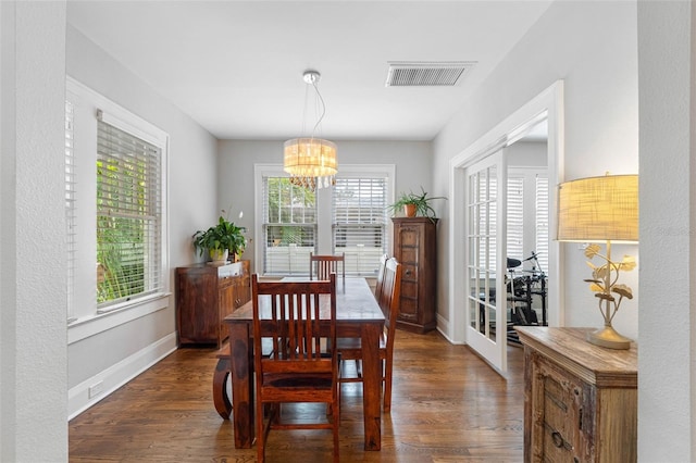 dining room featuring dark hardwood / wood-style floors and a chandelier