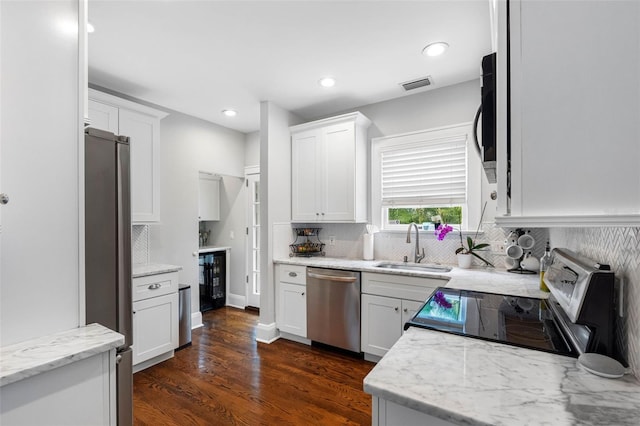 kitchen featuring white cabinetry, appliances with stainless steel finishes, and sink