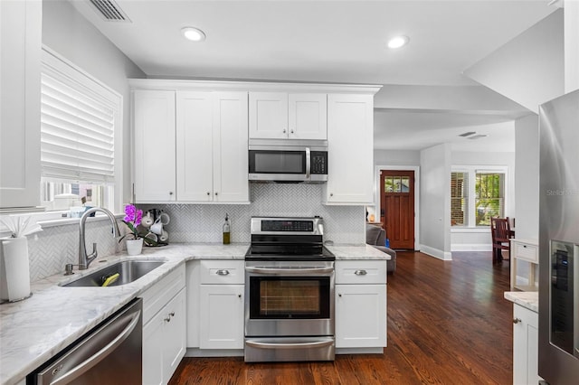 kitchen with appliances with stainless steel finishes, sink, and white cabinets