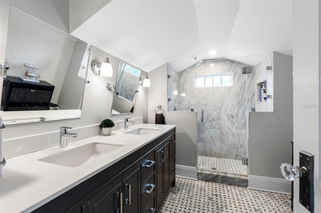 bathroom featuring an enclosed shower, vanity, and lofted ceiling