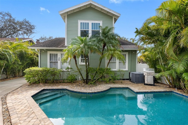 rear view of property featuring central air condition unit