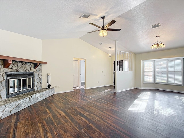 unfurnished living room with vaulted ceiling, visible vents, dark wood finished floors, and a stone fireplace