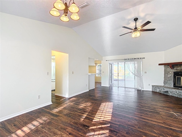 unfurnished living room with visible vents, dark wood-type flooring, a stone fireplace, baseboards, and ceiling fan with notable chandelier