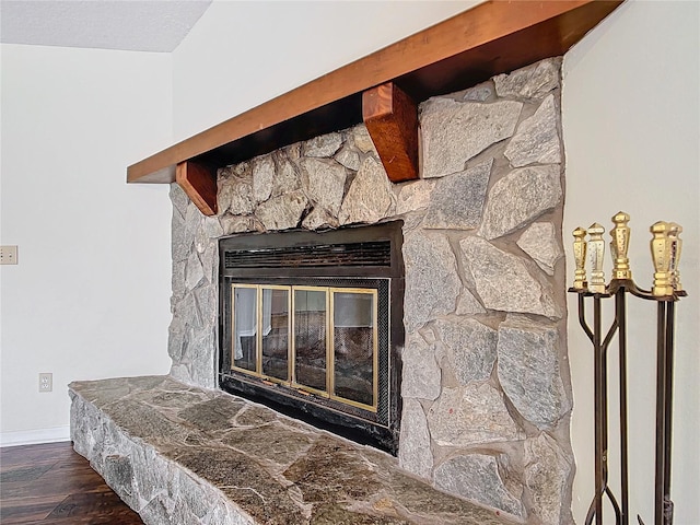 details with a fireplace, baseboards, and wood finished floors