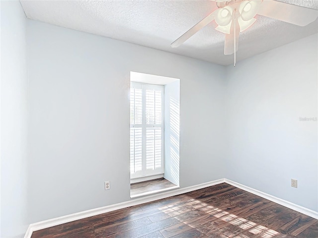 empty room featuring dark wood-style floors, a textured ceiling, baseboards, and a ceiling fan