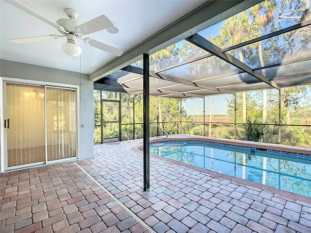 outdoor pool featuring a lanai, a patio area, and ceiling fan