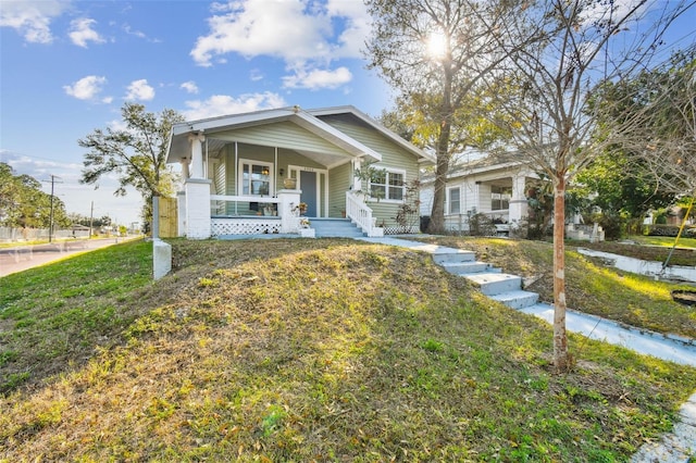 view of front of property with a front yard and a porch