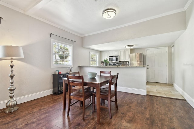 dining room featuring crown molding and dark wood-type flooring