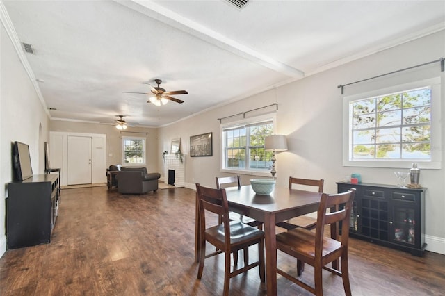 dining room featuring beam ceiling, dark wood-type flooring, and ornamental molding