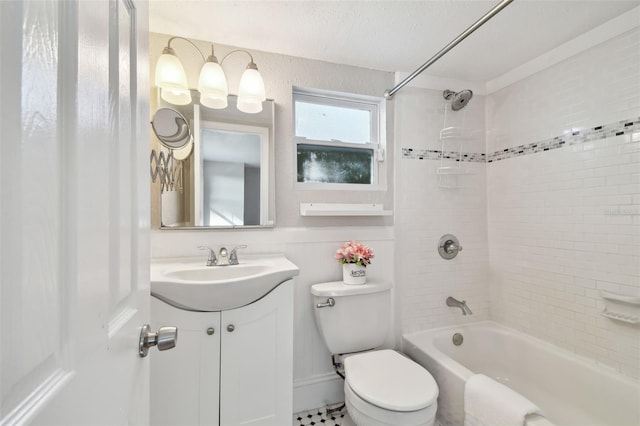 full bathroom with vanity, tiled shower / bath, and toilet