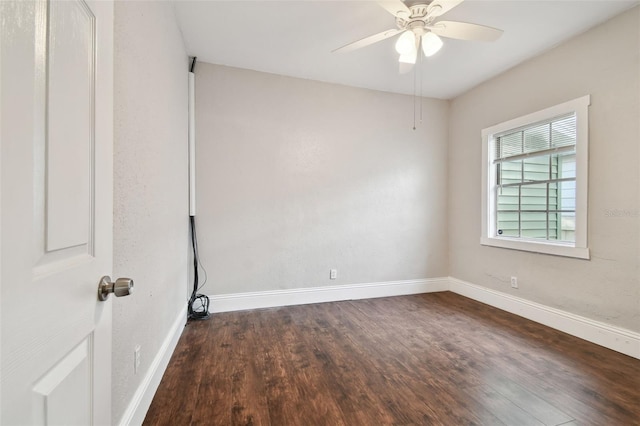 empty room featuring ceiling fan and dark hardwood / wood-style flooring