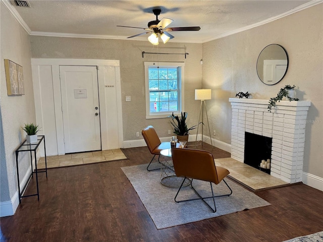 living room with ceiling fan, hardwood / wood-style flooring, crown molding, and a fireplace