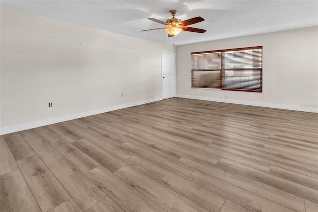 unfurnished room with ceiling fan, light hardwood / wood-style flooring, and a textured ceiling