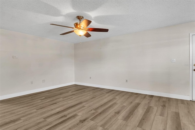 spare room featuring ceiling fan, a textured ceiling, and light hardwood / wood-style floors