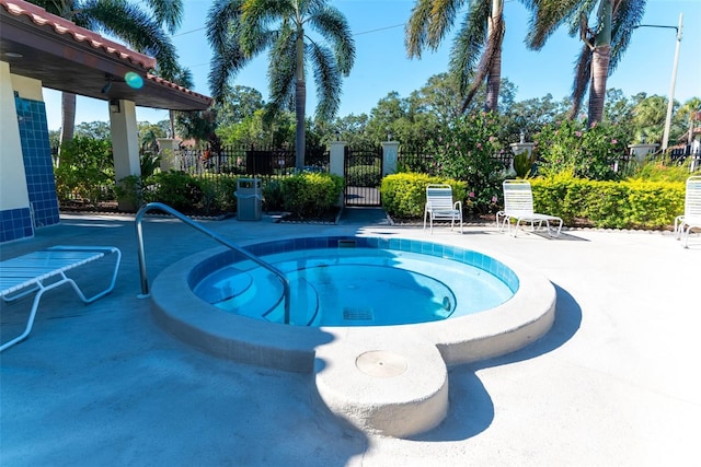 view of swimming pool featuring a community hot tub and a patio area