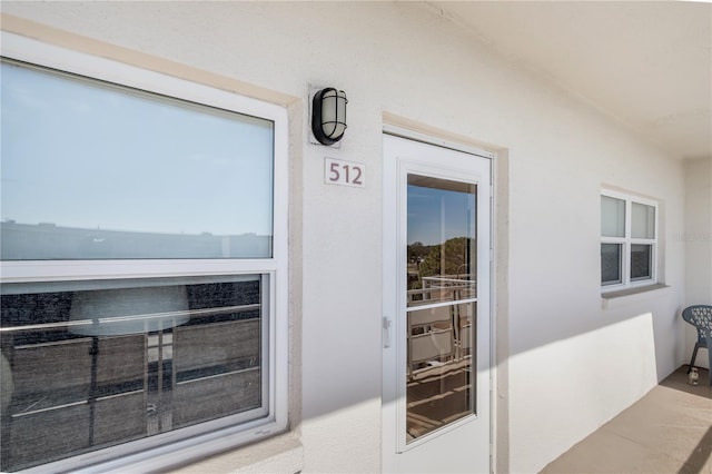 entrance to property with stucco siding