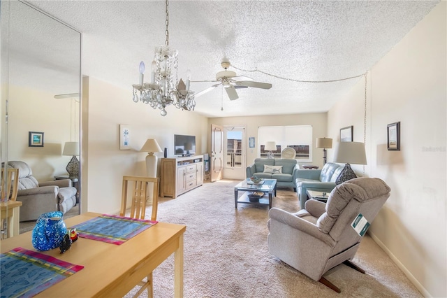 living area featuring light carpet, a textured ceiling, baseboards, and ceiling fan with notable chandelier