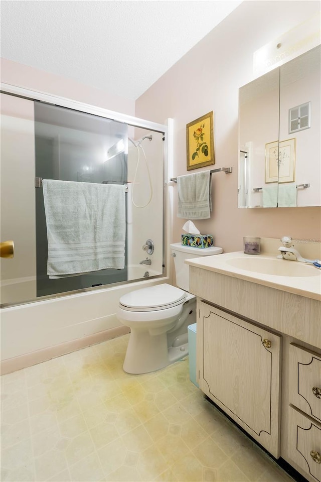 bathroom with shower / bath combination with glass door, visible vents, toilet, vanity, and a textured ceiling